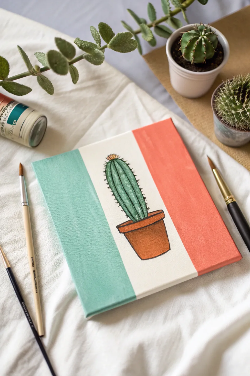 Color-blocked backgrounds make a simple cactus painting pop with bold contrast and calm minimal style.