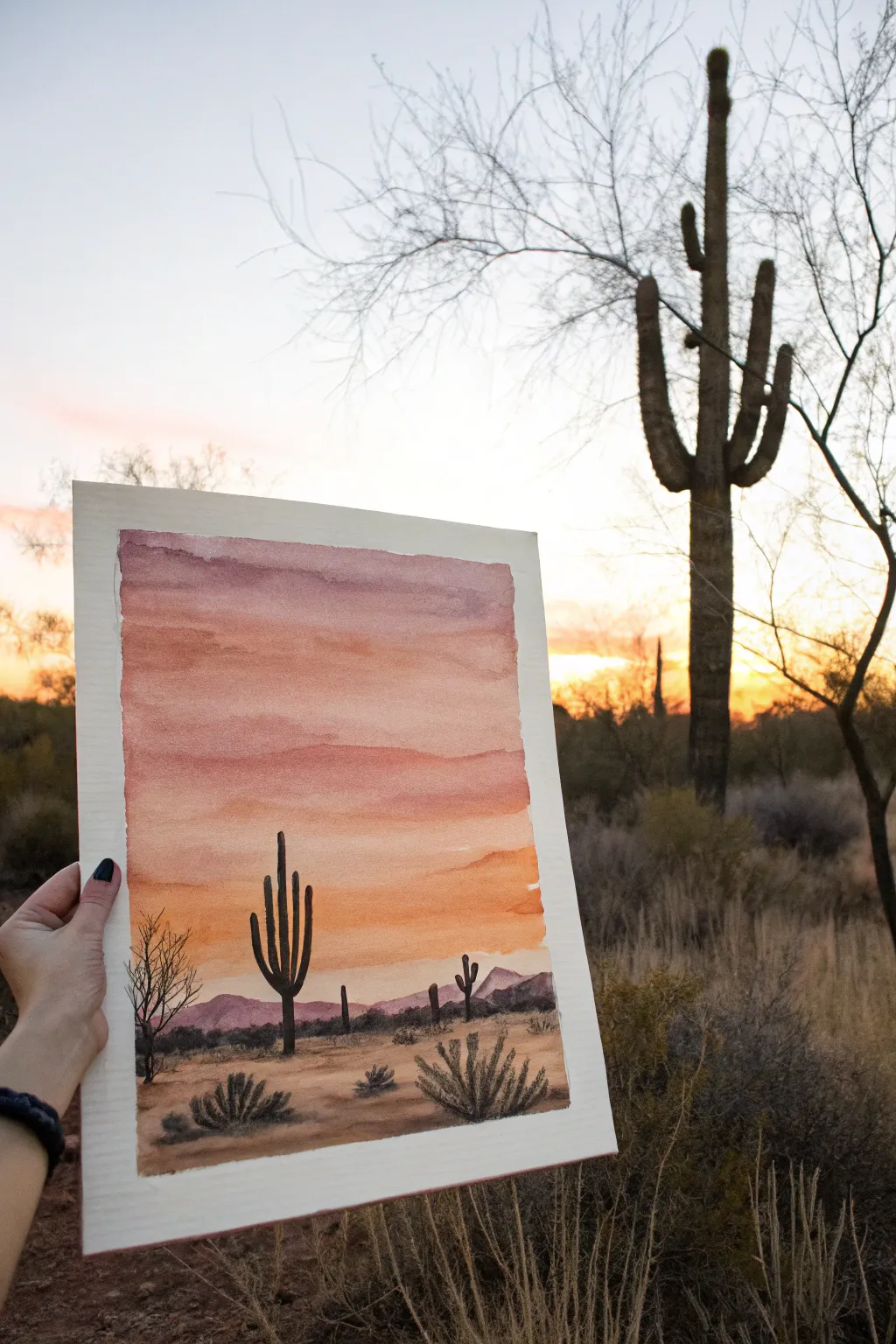 Warm desert sunset bands and bold cactus silhouettes for an easy, calming scenery painting idea.