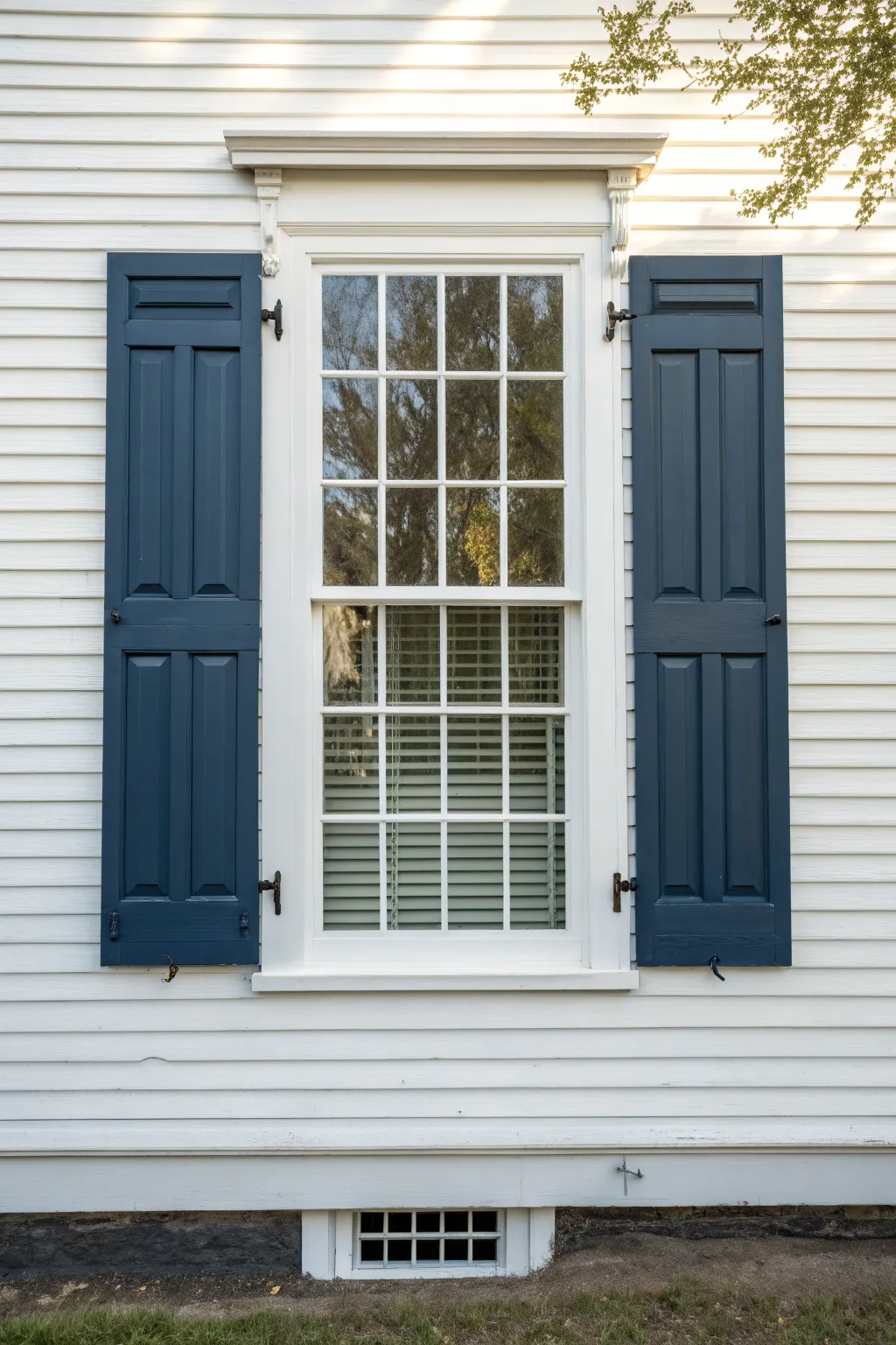 Crisp white siding and deep navy shutters create timeless colonial symmetry with modern ease