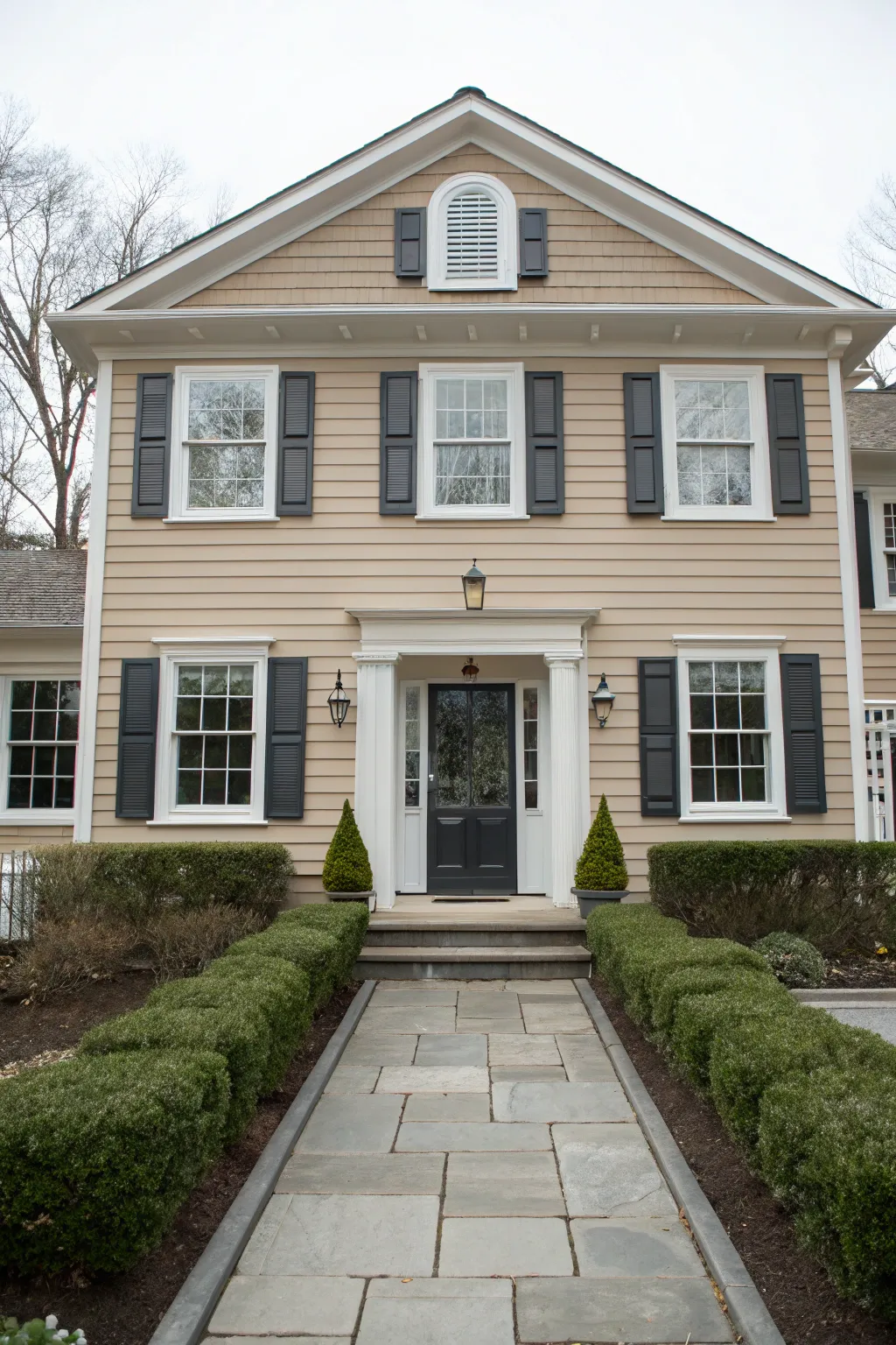 Taupe siding with crisp white trim and dark shutters for timeless, high-contrast curb appeal