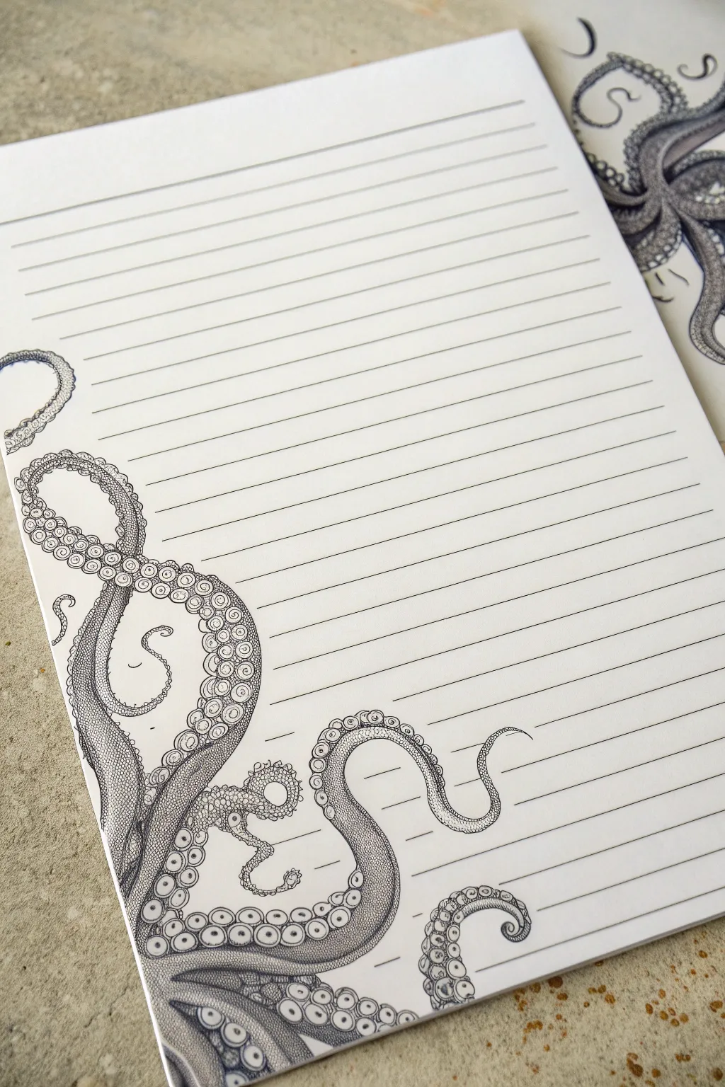 Octopus tentacles weave through notebook lines, a minimalist pencil study with deep contrast.