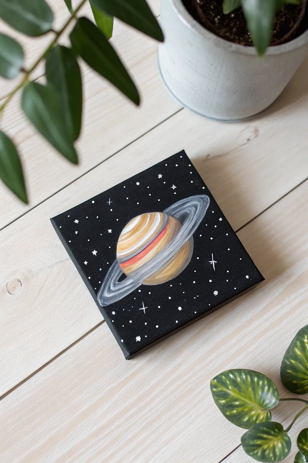 Paint the stars with this dreamy mini Saturn canvas idea. Simplicity meets the cosmos.