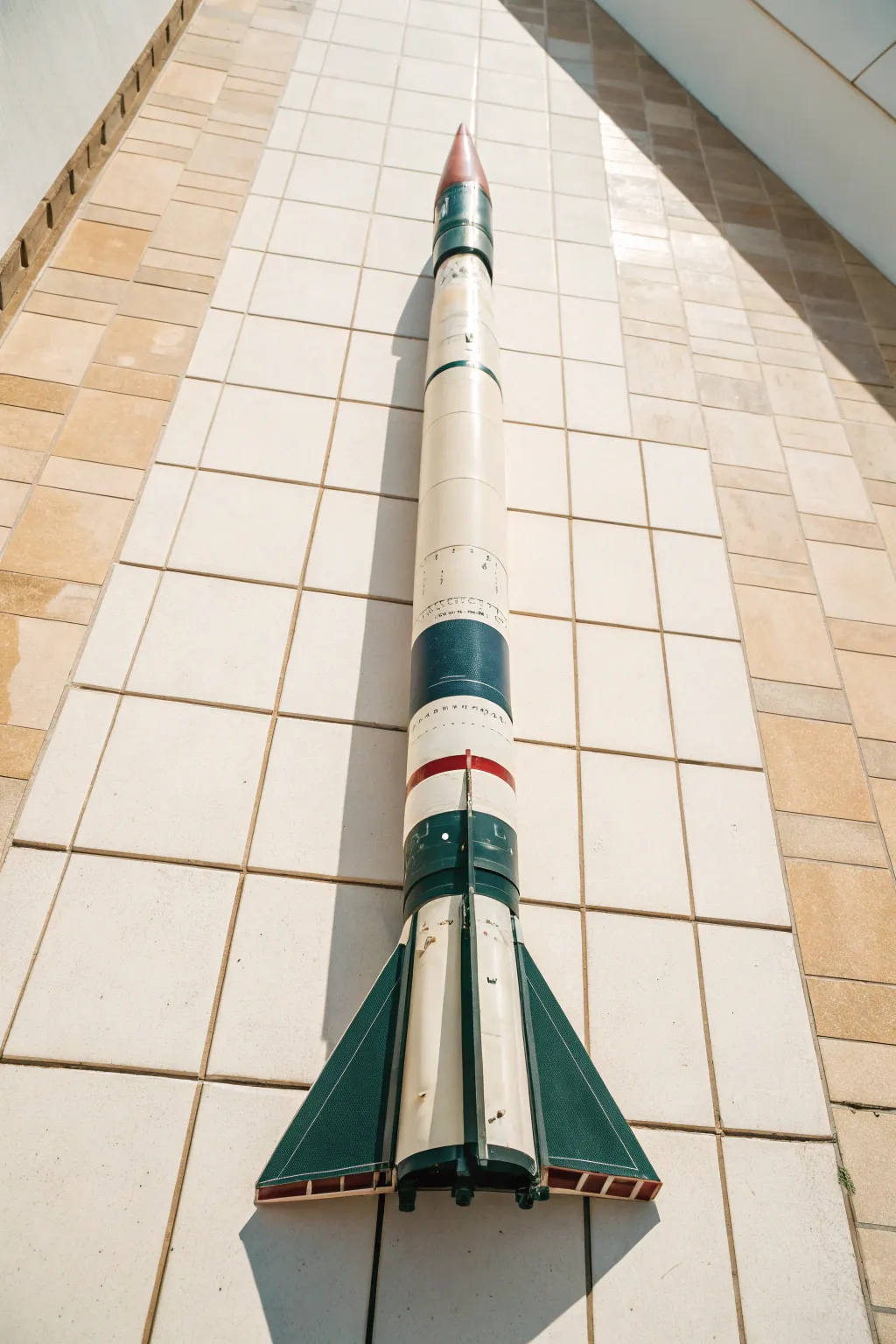 Three-color geometric wrap panels on a model rocket, shown top-down for clean alignment