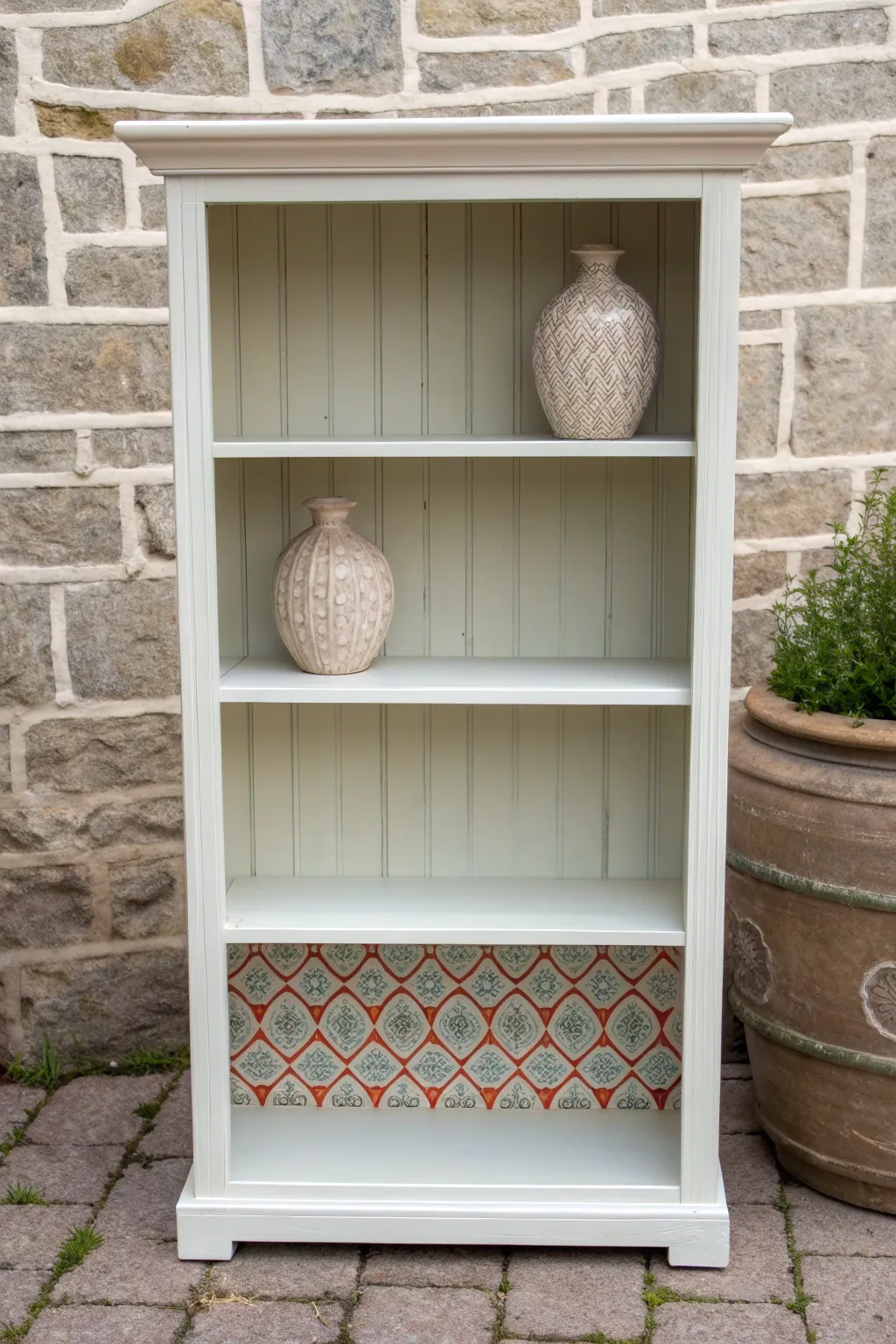 Two-tone stencil back panel makes a painted bookcase feel modern, calm, and subtly boho