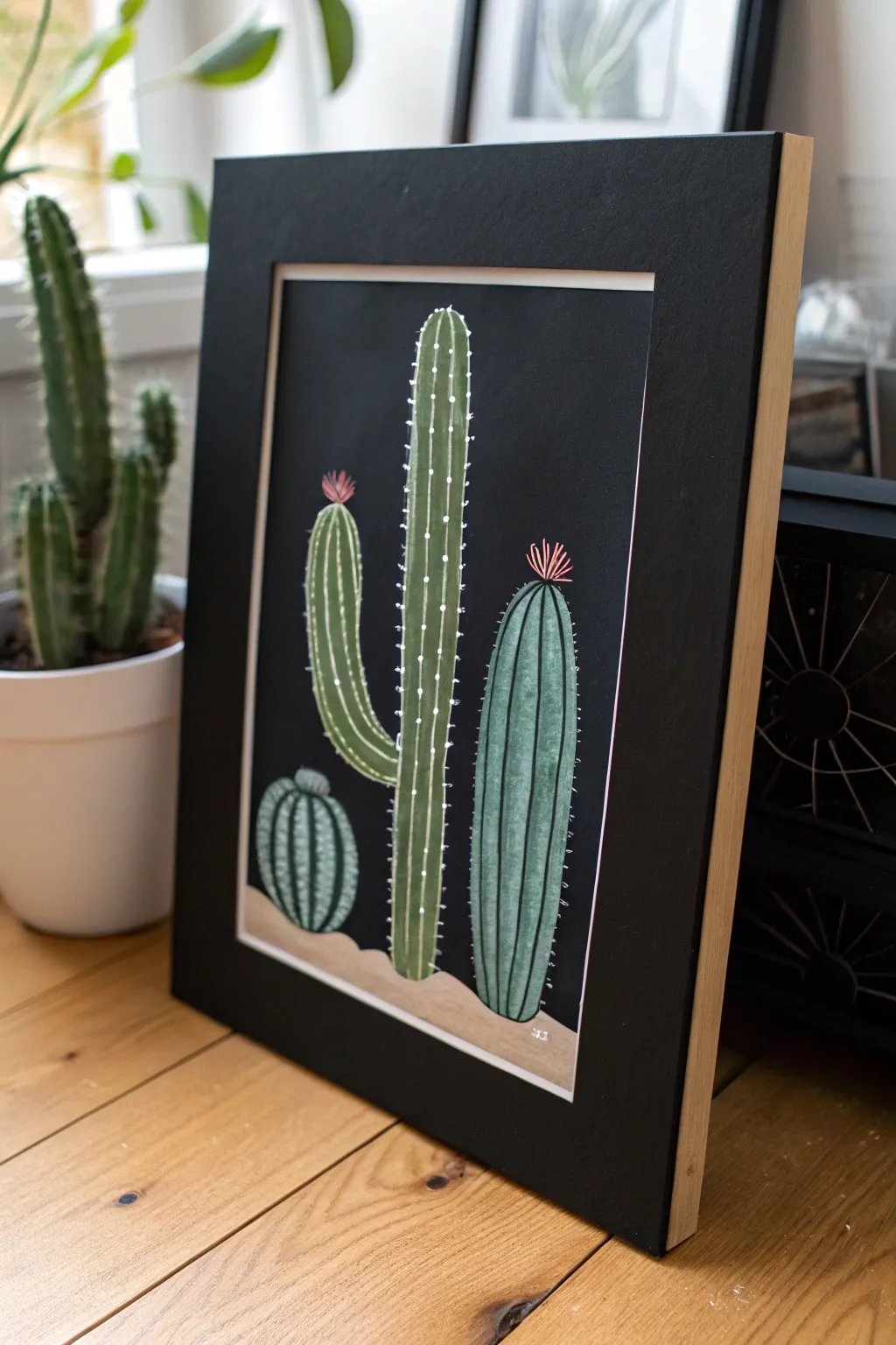 Cactus trio on a black background with minimal highlights, an easy minimalist boho painting idea
