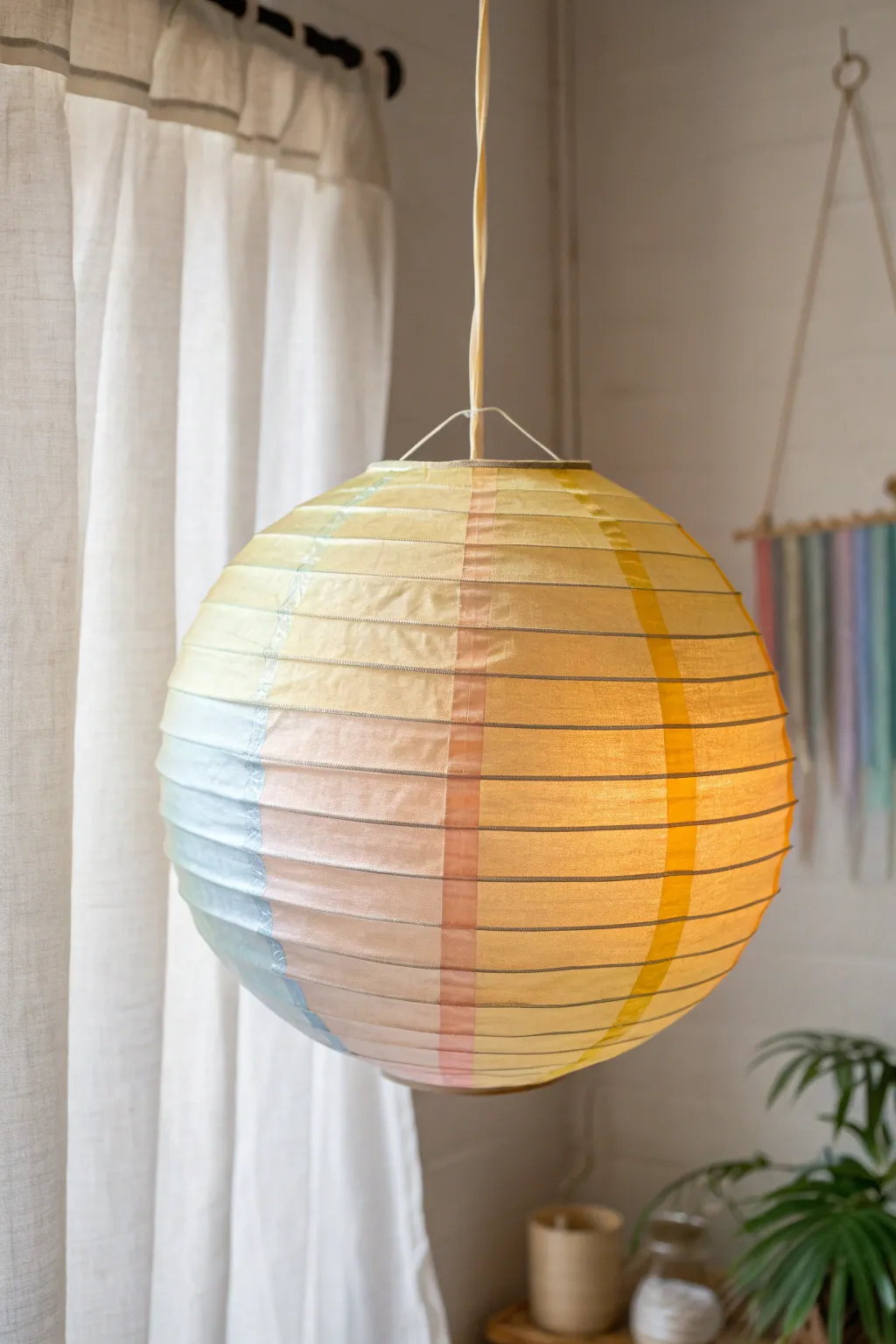 Paint a glowing paper lantern with soft rainbow bands for an easy sunny minimalist boho look