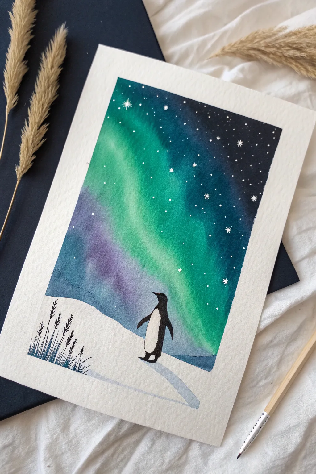 Paint a lone penguin beneath aurora ribbons for a calm, high-contrast winter night scene