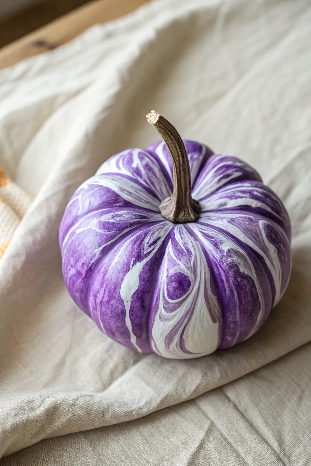 Top-down purple pumpkin with violet-lavender marble swirls, minimalist Scandinavian boho contrast.