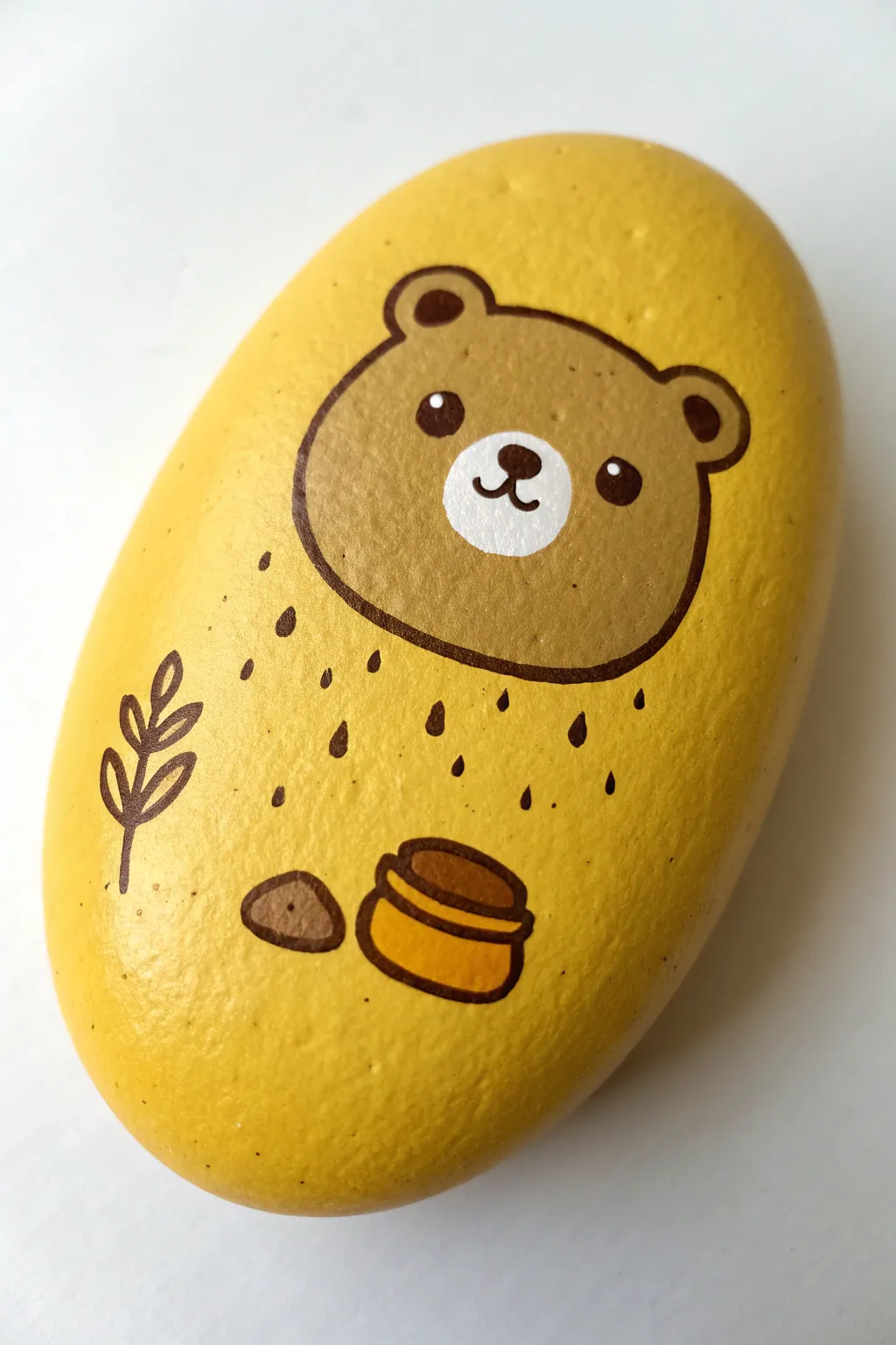 Cozy Disney-inspired bear and honey pot rock: minimalist, warm tones, easy to recreate.