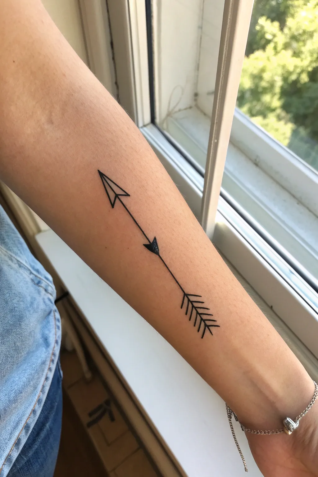 Small straight arrow tattoo line art, minimalist and clean, perfect simple tattoo inspiration