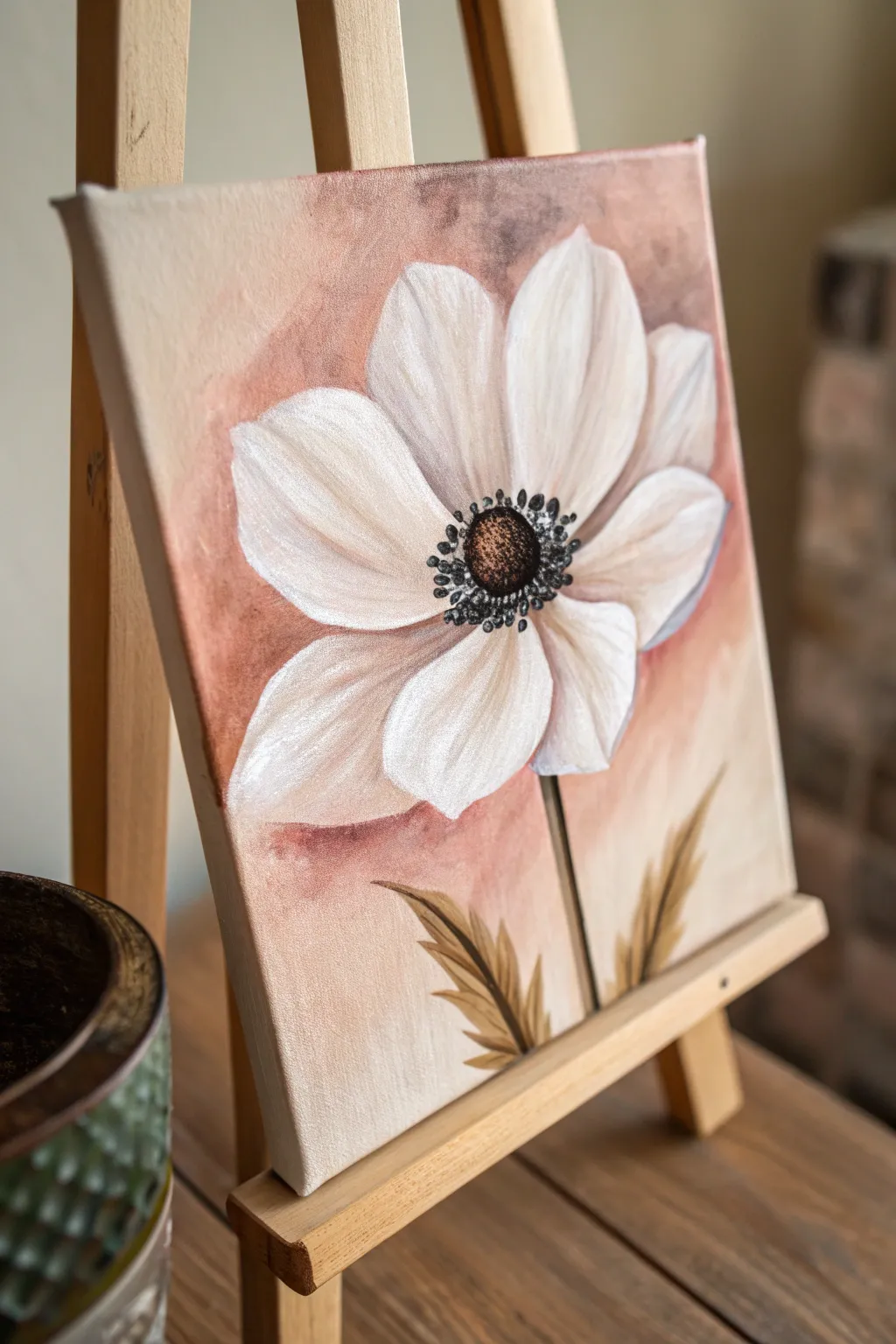 Paint a bold single bloom on a tiny square canvas for instant minimalist boho charm.