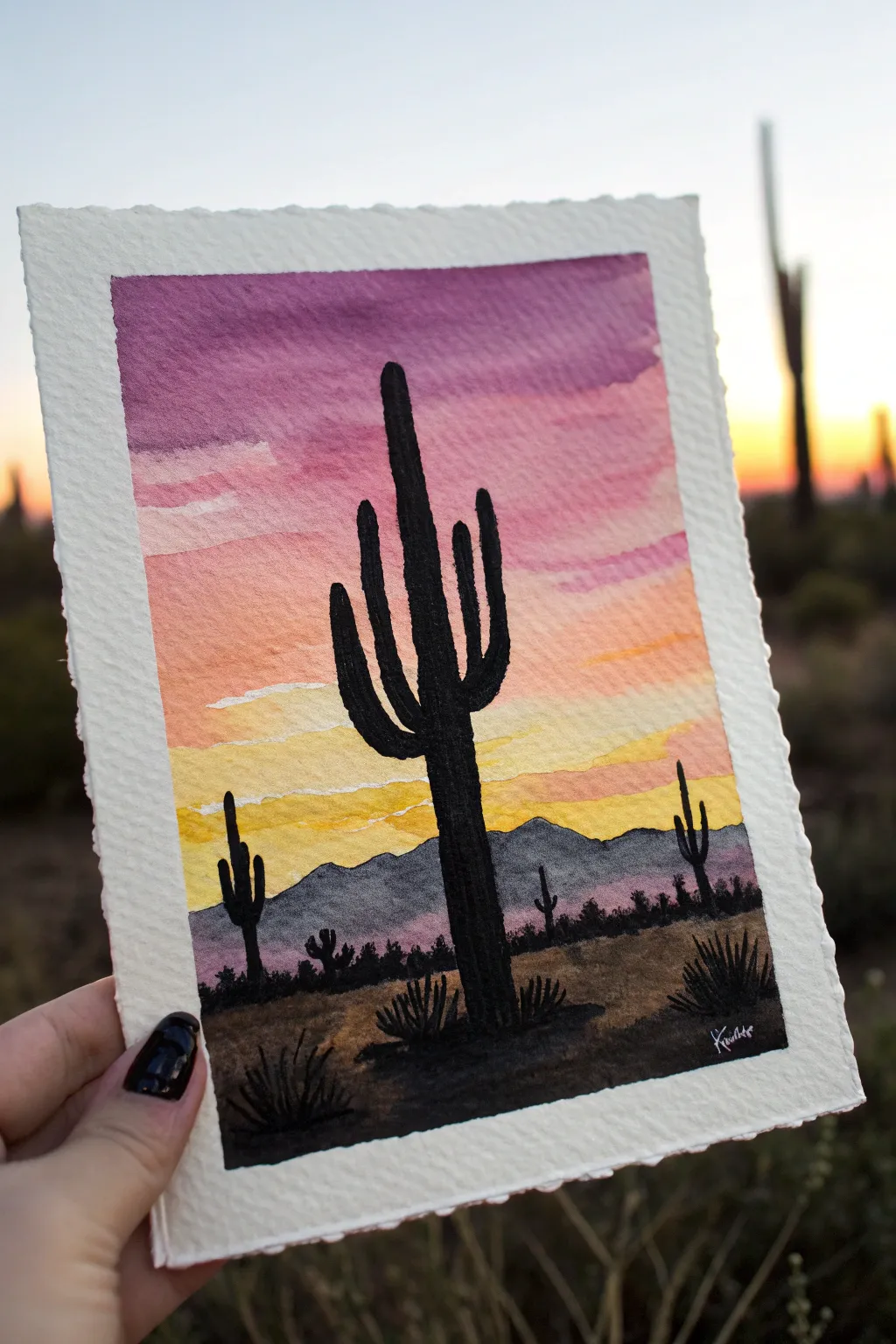 Paint a bold cactus silhouette against a golden to violet desert sunset gradient.