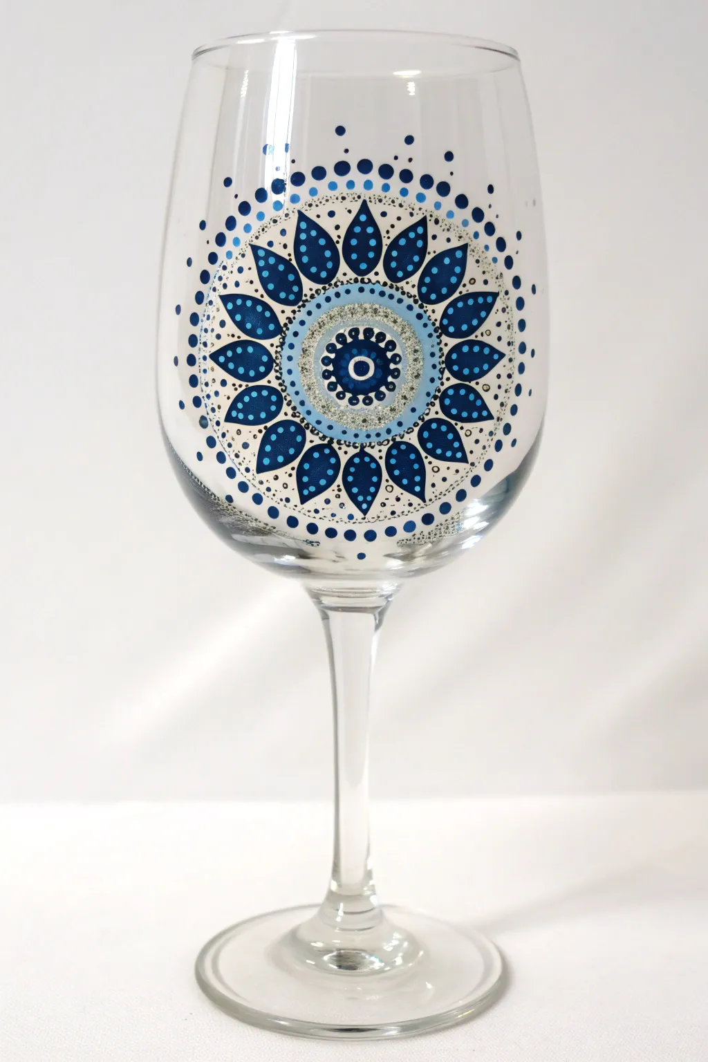 Elegant mandala dot art on a wine glass in cool blues, minimal, boho, and beginner-friendly